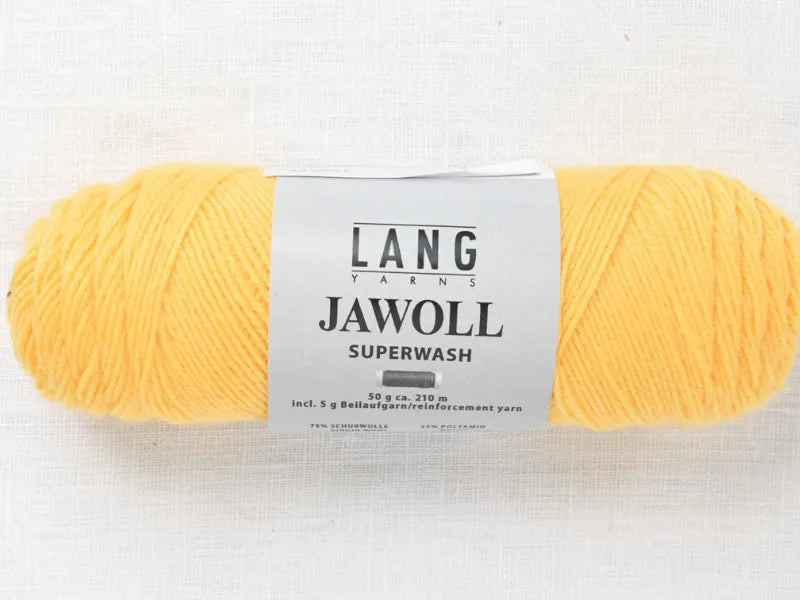 A skein of yellow Lang Yarns Jawoll Superwash (from Timo sukka ohje fingerin ja Lang jawoll) with a white label on light fabric—perfect for your next neulontaohje project, featuring clear product details and branding in black text.
