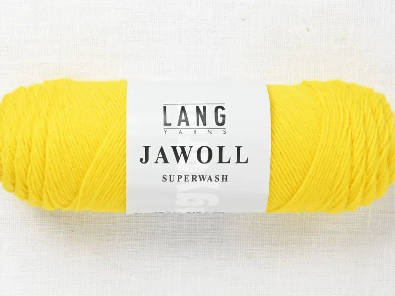 A skein of bright yellow Timo sukka ohje fingerin ja Lang jawoll yarn, sporting a white LANG YARNS JAWOLL SUPERWASH label, ideal for your next neulontaohje, is displayed on a light textured background.