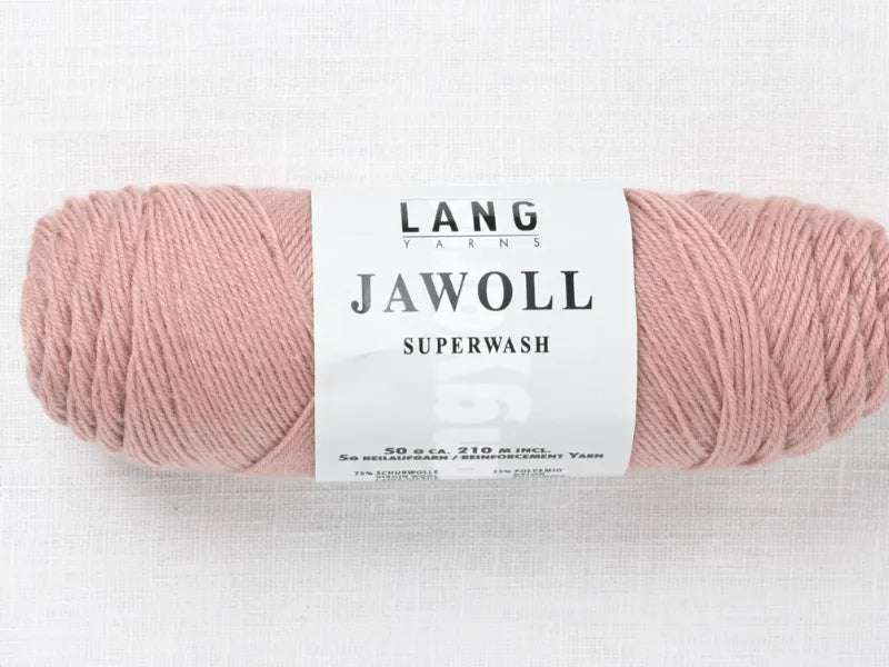 A skein of light pink Lang Jawoll Superwash fingering yarn, shown on a white textured surface, is ideal for the Timo sukka ohje fingerin ja Lang jawoll project—perfect for your next knitting pattern.