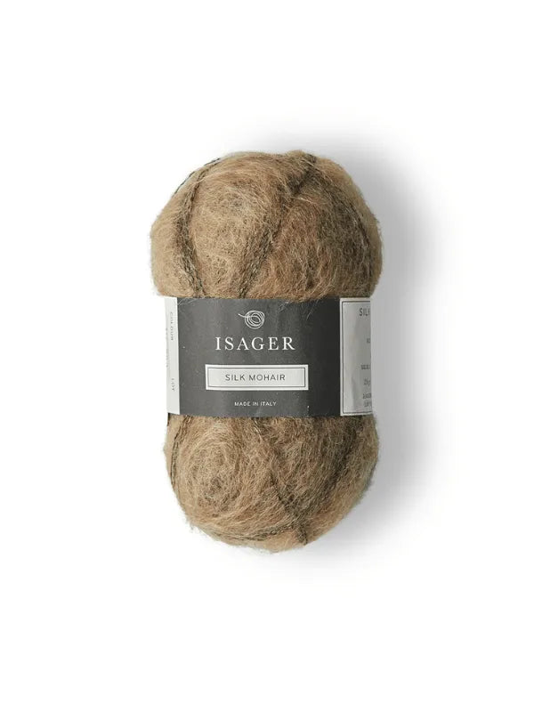 The Cumulus Blouse neuleohje + Isager Silk Mohair features a skein of light brown yarn with a dark gray and silver label, perfect for your next knitting project, displayed on a plain white background.