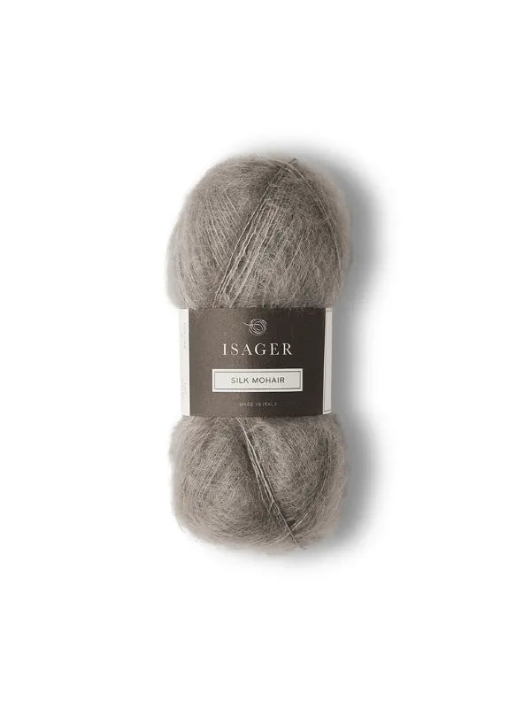 The Cumulus Blouse neuleohje + Isager Silk Mohair features a skein of light grey yarn with a dark label, ideal for your next knit project and shown on a white background.