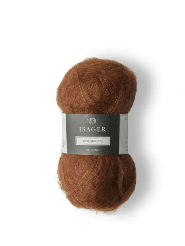 A skein of Isager Silk Mohair in warm brown, with a gray and white label, is shown on a white background—perfect for making the Cumulus Blouse neuleohje.