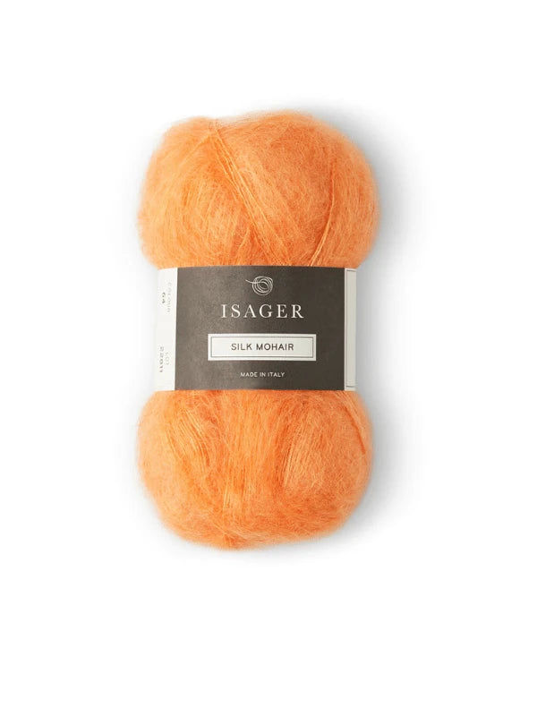 A skein of orange Isager Silk Mohair yarn with a gray and white label, ideal for your next Cumulus Blouse neuleohje project, is shown on a white background. Product: Cumulus Blouse neuleohje + Isager Silk Mohair.