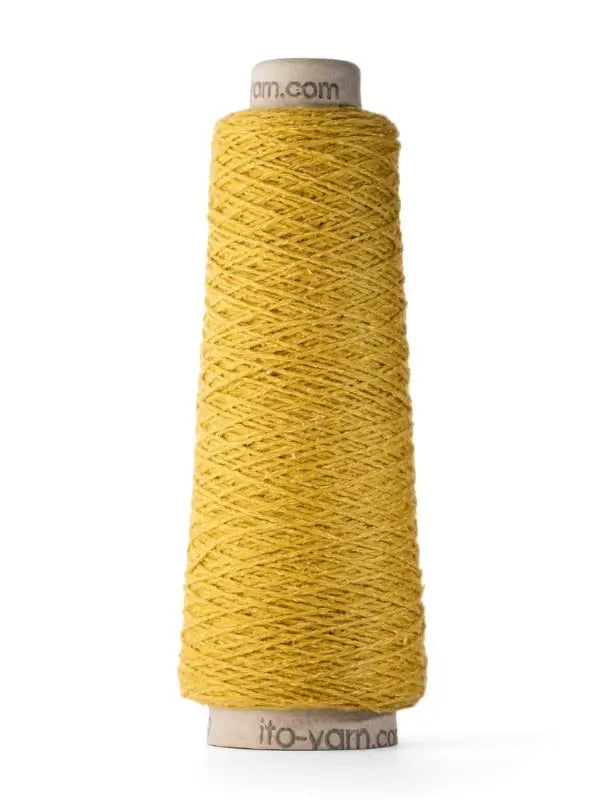 An upright cone of Ito Yarn Shimo in yellow is displayed against a white background. The merinovillalanka yarn is neatly wound around a cardboard core, with the texture of the fibers clearly visible.