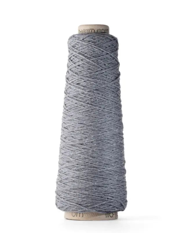 A tall cone of Ito Yarn Shimo in light gray merinovillalanka is tightly wound around a cardboard spool, standing upright against a plain white background.