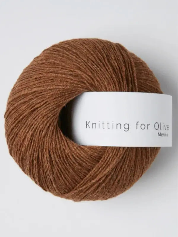 A ball of brown Knitting for Olive Merino yarn with a white label and Öko-Tex certification, shown against a plain background.