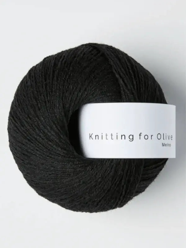 A skein of Knitting for Olive Merino yarn with a white paper band wrapped around the center.