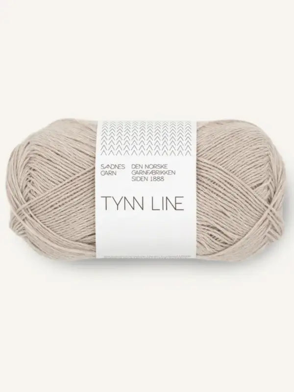 A ball of Sandnes Garn Tynn Line, a fingering-weight yarn with Norwegian text on a white band—ideal as a kesäneulelanka for summer knits.
