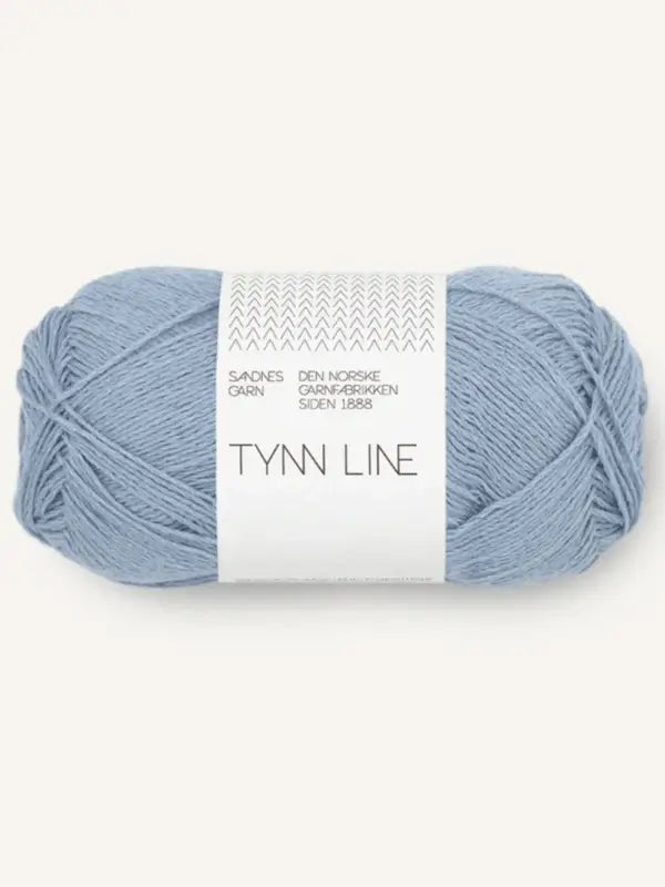 A skein of Sandnes Garn Tynn Line light blue yarn with a white label featuring decorative details—ideal for kesäneulelanka or fingering-vahvuinen lanka projects.