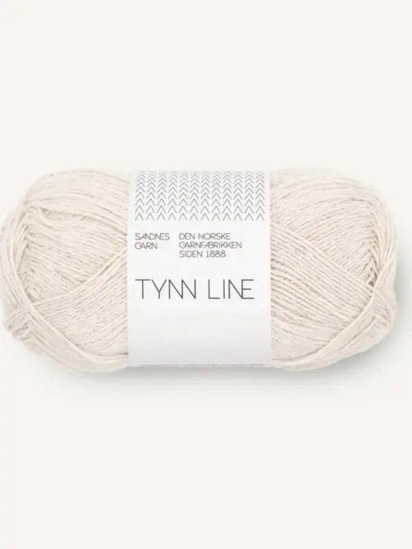 A skein of Sandnes Garn Tynn Line in light beige, a fingering-weight kesäneulelanka, wrapped in a simple white band with text and a small zigzag pattern at the top.