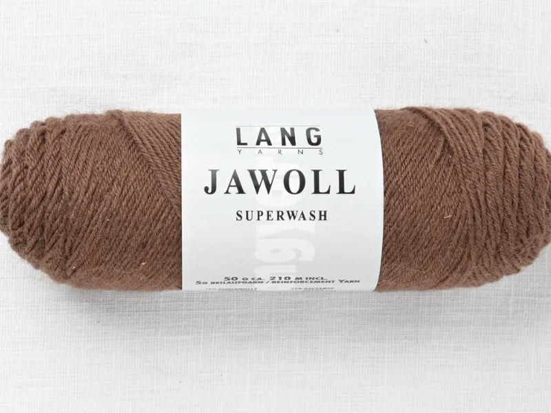 A skein of brown Timo sukka ohje fingerin ja Lang jawoll fingering yarn rests on a white surface, wrapped in a white label that shows the brand and product name in black letters.