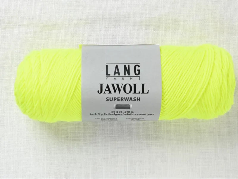 A skein of Timo sukka ohje fingerin ja Lang jawoll in bright yellow rests on a white textured surface, its label showing weight, length, and care instructions—ideal for neulontaohje or your next knitting project.