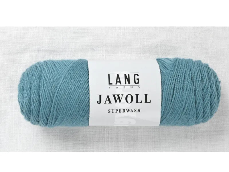 A skein of light blue Timo sukka ohje fingerin ja Lang jawoll yarn rests on a white surface, perfect for your next knitting or sock project.