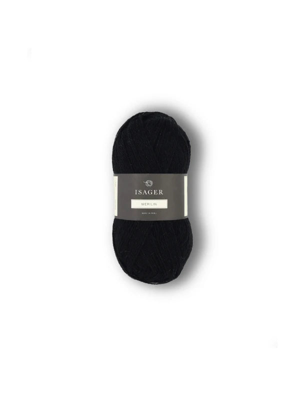 A skein of Isager Merlin yarn in black, featuring a gray and white band, is shown against a plain white background.
