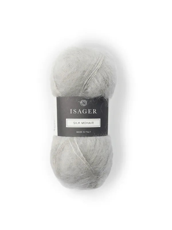 The Cumulus Blouse neuleohje + Isager Silk Mohair features a skein of light gray yarn with a black and white label, perfect for your next knitting project, beautifully displayed on a white background.