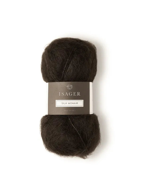 A skein of dark brown Isager Silk Mohair, featured with the Cumulus Blouse neuleohje, has a gray label showing brand and fiber type, displayed against a white background.