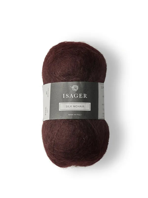 A skein of Isager Silk Mohair in deep brown with a gray and white label featuring the brand, shown on a white background—ideal for your next Cumulus Blouse neuleohje project. Product: Cumulus Blouse neuleohje + Isager Silk Mohair.