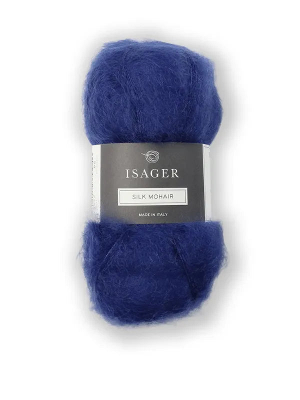 A skein of deep blue Isager Silk Mohair with its ISAGER label, alongside the Cumulus Blouse neuleohje—ideal for your next knitting project against a crisp white background.