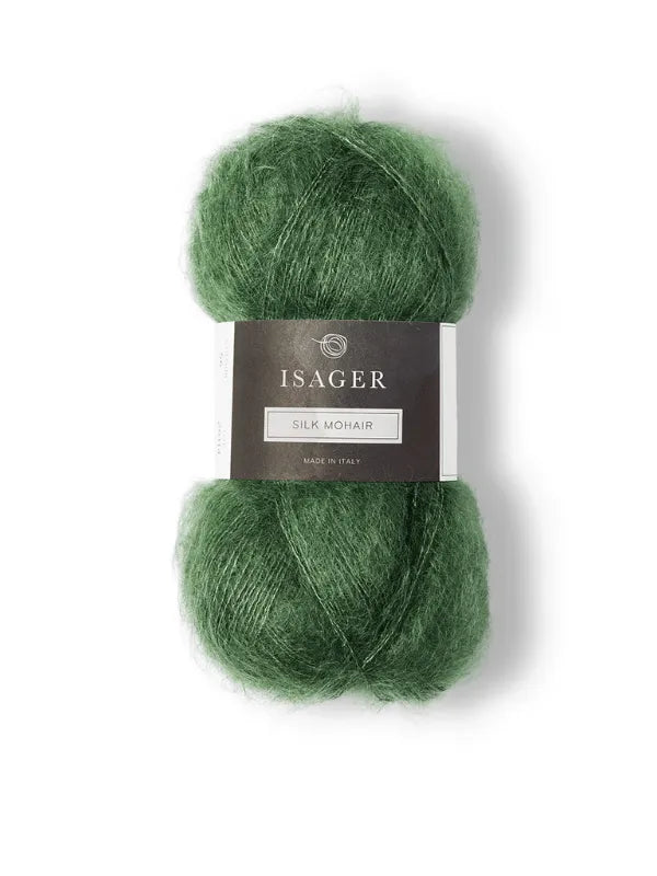 A ball of green Isager Silk Mohair yarn, labeled with a gray and white band, is shown with the Cumulus Blouse neuleohje pattern—ideal for your next knitting project—against a white background.