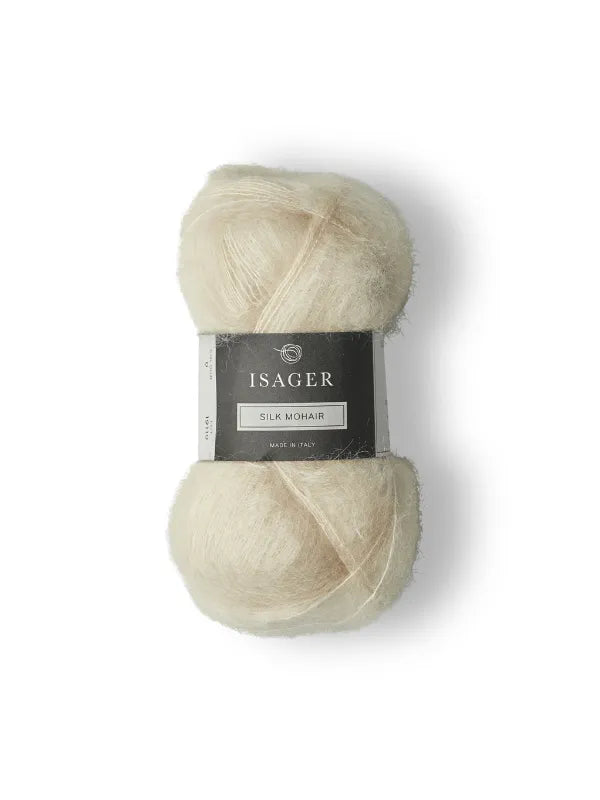 A skein of creamy white Isager Silk Mohair yarn, labeled in black and gray, with the Cumulus Blouse neuleohje pattern—ideal for your next knit—shown on a plain white background.