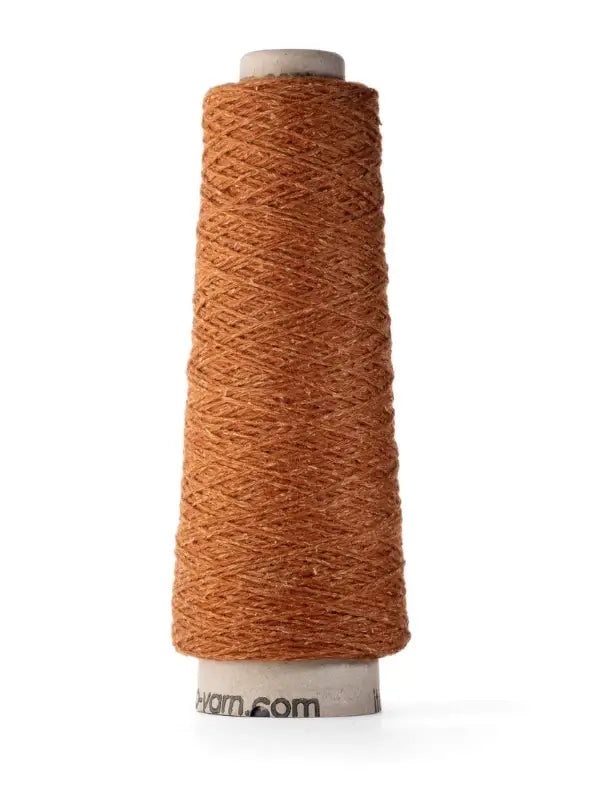 A spool of Ito Yarn Shimo in brown is wound tightly around a white cylindrical core, standing upright against a plain white background.
