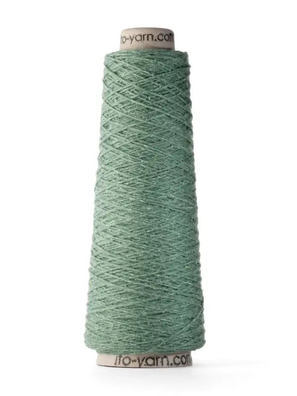 A cone of light green yarn with visible texture, wound around a cardboard spool and standing upright on a white background; this is Ito Yarn Shimo, an exquisite blend featuring merinovillalanka that elevates its softness and quality.