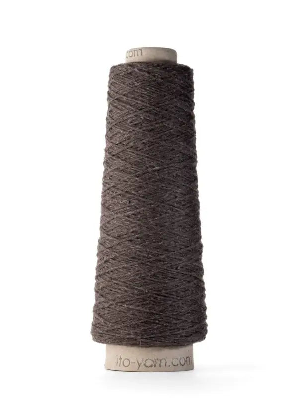 A spool of dark brown Ito Yarn Shimo is wound around a tall, narrow cardboard cone, standing upright on a white background.