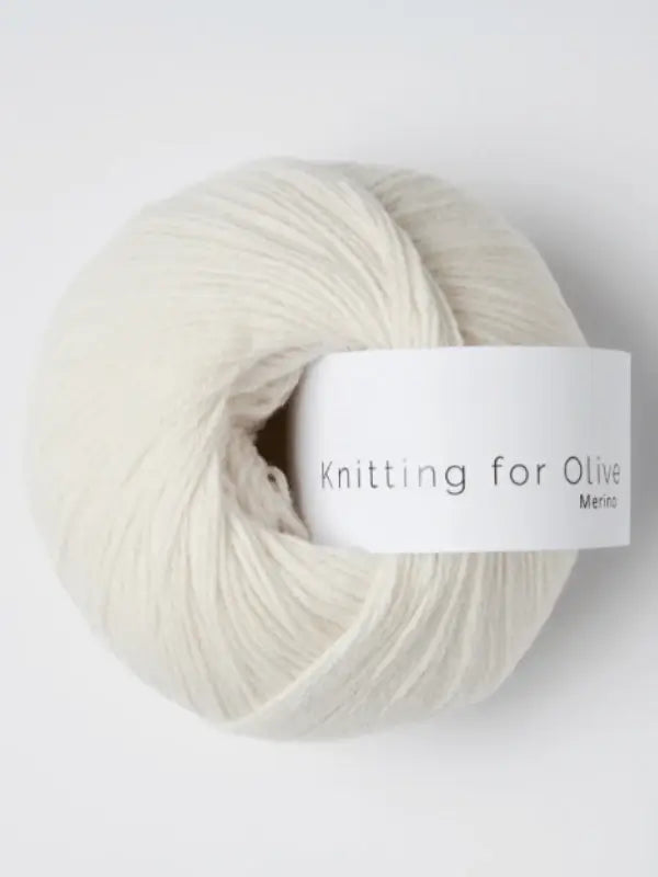 A ball of Knitting for Olive Merino yarn, soft and off-white, is displayed against a plain white background.