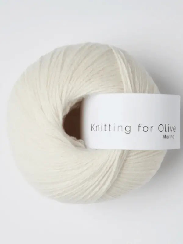A soft, off-white ball of Knitting for Olive Merino yarn with a white label in gray text, Öko-Tex certified, is displayed on a plain white background.