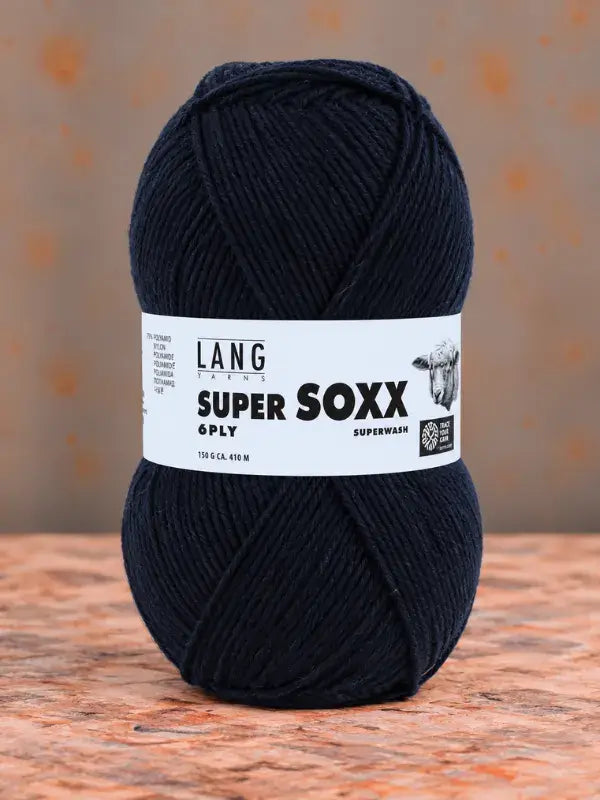 A ball of dark navy blue Lang Yarns Super Soxx 6 ply – kestävä sukkalanka villasta yarn wrapped with a paper label.