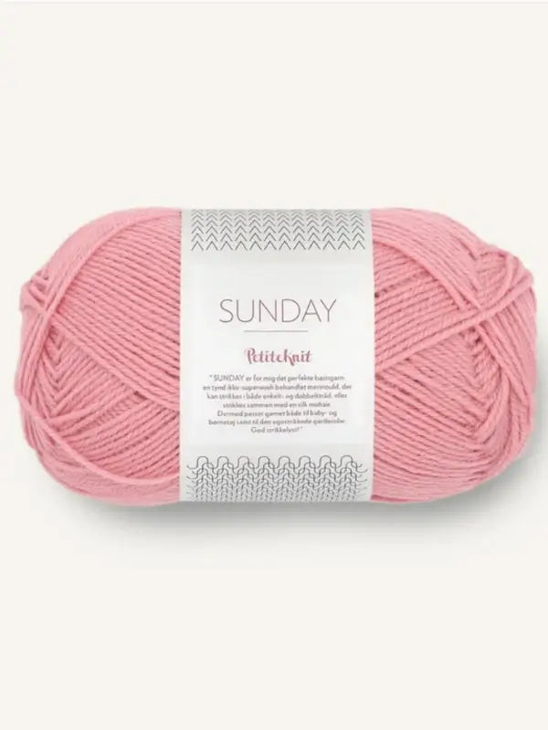 A skein of pink, mulesing-vapaa merinovillalanka labeled Sandnes Garn Sunday with a white and gray wrapper, displayed on a light background.