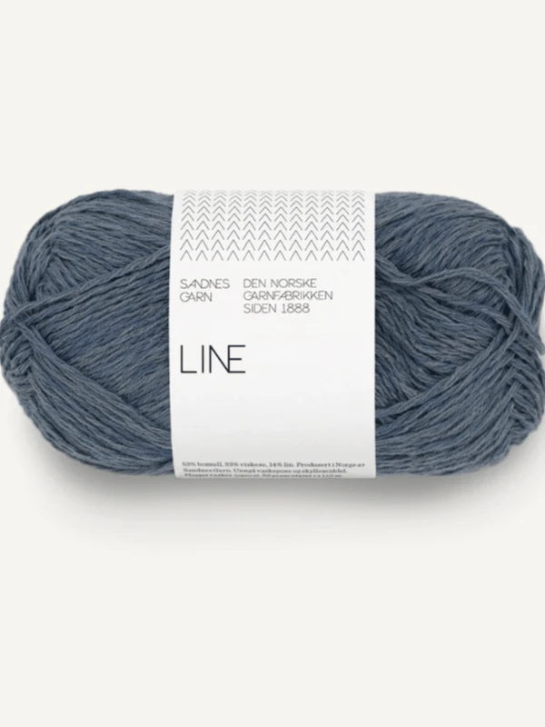 A skein of blue-gray Sandnes Garn Line yarn with a white label, ideal for your Milly Sweater & Skirt Neuleohje Suomi +Sandnes Garn line project. Perfectly wound and ready to use against a light background.