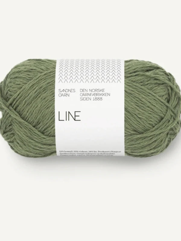 A skein of sage green Sandnes Garn Line yarn with a white LINE label (Norwegian text), perfect for the Milly Sweater & Skirt Neuleohje Suomi neulesetti, neatly wound against a light background.